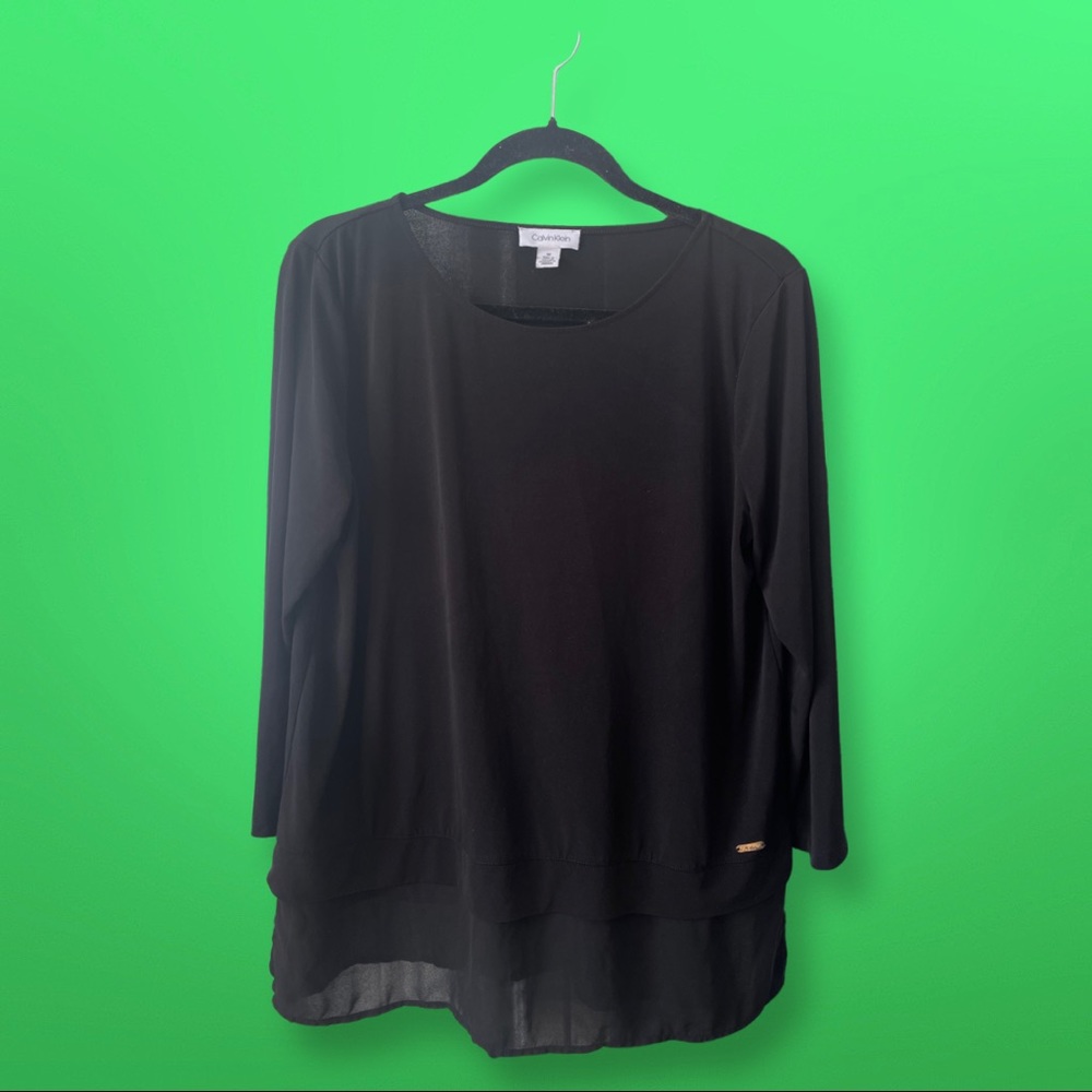 Black Calvin Klein blouse with sheer fabric at the bottom. Size M.